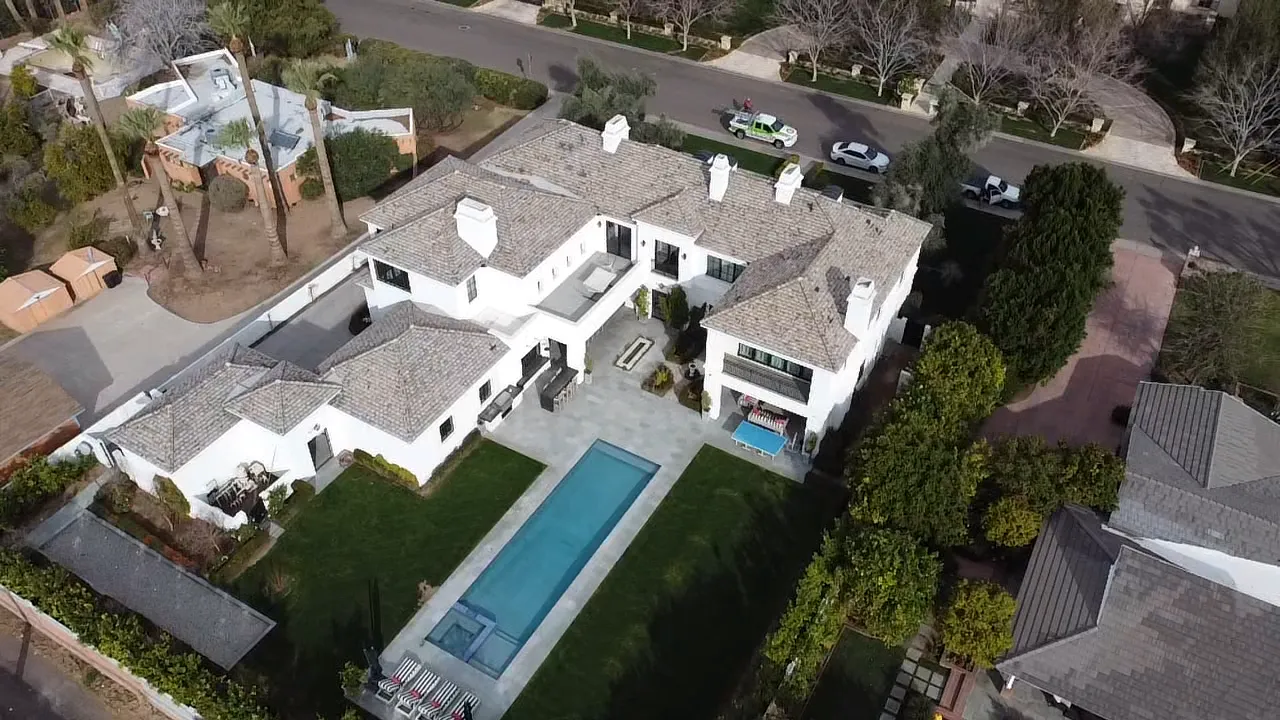 Aerial view of a large home with a completed tile roof