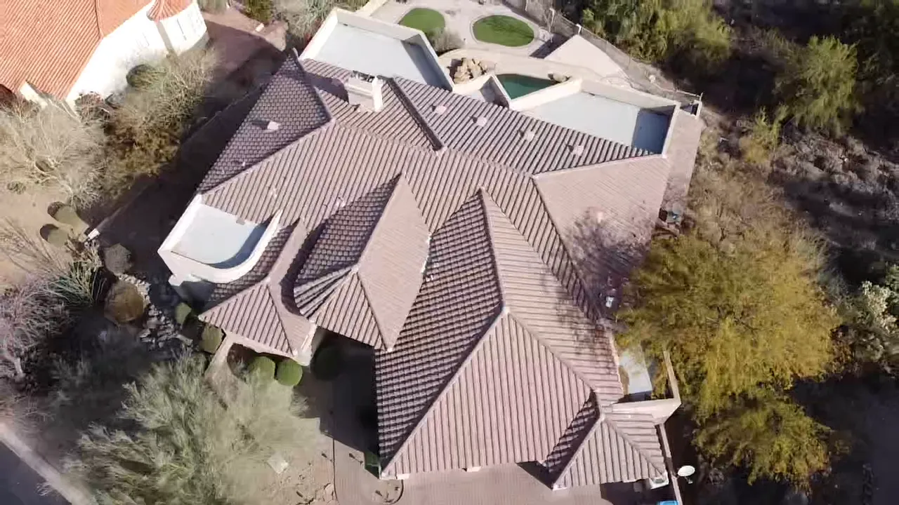 Aerial view of a completed tile roof on a residential property